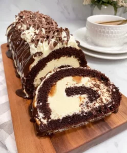 Velvety chocolate roll dessert with whipped cream filling on a plate