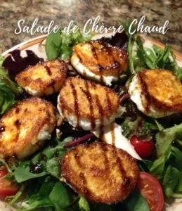 Delicious warm goat cheese salad with mixed greens and vinaigrette dressing.
