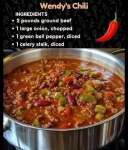 Bowl of Wendy's Chili topped with cheese and onions, served hot and ready to eat.