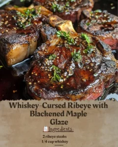 Whiskey-Cursed Ribeye steak with Blackened Maple Glaze plated beautifully.