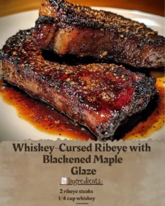 Whiskey-Cursed Ribeye with Blackened Maple Glaze plated and garnished