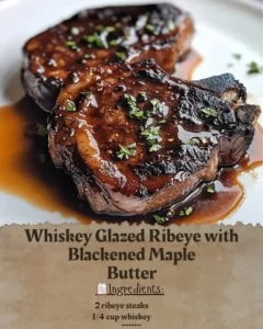 Whiskey Glazed Ribeye steak topped with Blackened Maple Butter for a gourmet treat.