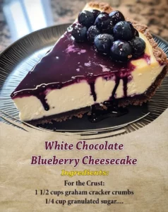 Delicious slice of white chocolate blueberry cheesecake topped with fresh blueberries