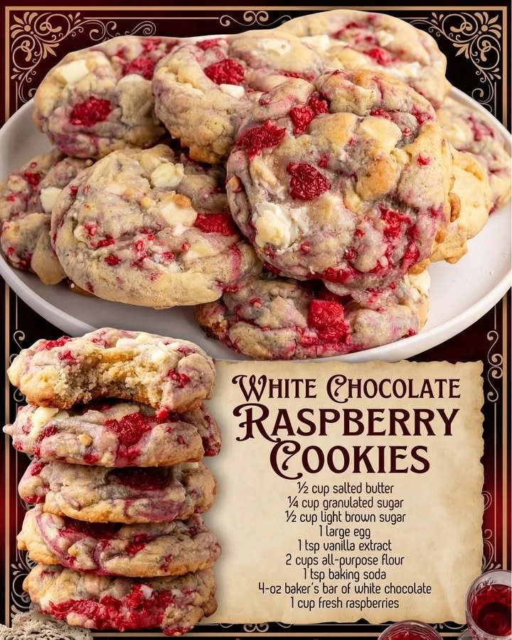 Freshly baked white chocolate raspberry cookies with vibrant raspberries.
