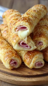 Baked ham and cheese mozzarella sticks served on a plate