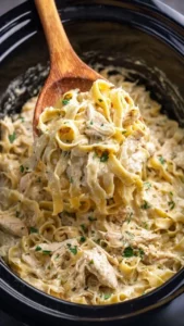 Crock Pot Chicken and Noodles meal served in a bowl with herbs on top.