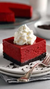 No Bake Red Velvet Cheesecake topped with cream and chocolate shavings.