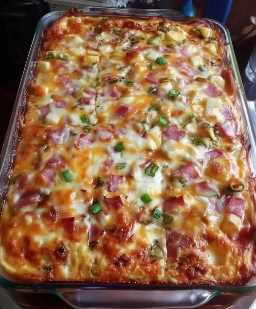 Delicious potato, egg, cheese, ham, and onion casserole baked to perfection