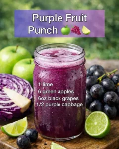 Vibrant Purple Fruit Punch in a glass, garnished with fresh fruits.