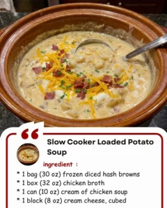 Bowl of slow cooker loaded potato soup topped with cheese and chives