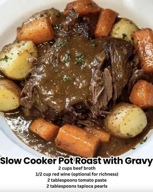 Slow Cooker Pot Roast served with rich gravy in a serving dish