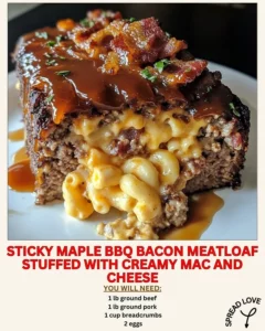 Sticky maple BBQ bacon meatloaf stuffed with creamy mac and cheese, served on a plate.